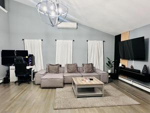 a living room with a couch and a table at Nature's Haven in the Hamptons in East Hampton