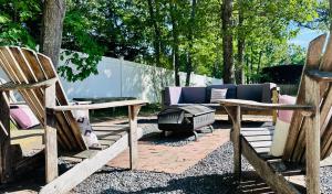 a backyard with two chairs and a fire pit at Nature's Haven in the Hamptons in East Hampton