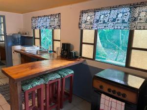 eine Küche mit einer Holztheke und 2 Fenstern in der Unterkunft Franky's Fare in Fare