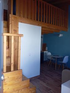 a large white door in a room with a table at Love Tiny House in Faro