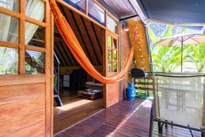 an open door of a house with an umbrella at EUCALYPTO CHALET in Guarne