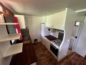 a small kitchen with a stove and a refrigerator at Villa ALBA in Maroe +23 photos