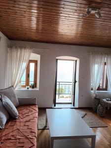 a living room with a couch and a table at Seaview studio in Neapoli Voion