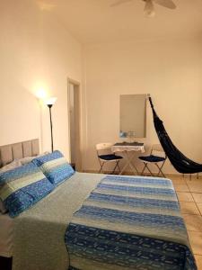 a bedroom with a bed and a hammock in it at Jóia no Bairro de Fátima - Lapa in Rio de Janeiro