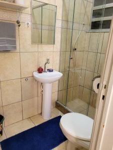 a bathroom with a toilet and a sink and a shower at Jóia no Bairro de Fátima - Lapa in Rio de Janeiro