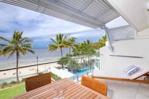 a balcony with a view of the beach and the ocean at Fairshore 38 Beachfront Balcony in Noosa Heads