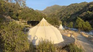a large tent in the middle of a river at Paradise Ranch Inn - Abundance Tent in Three Rivers