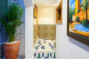 a room with a bench and a painting at Luxurious Riad Center Rabat Dar Al Jeld in Rabat
