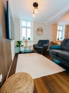 a living room with a couch and a rug at SecretApartment: Fewo in Warburg in Warburg