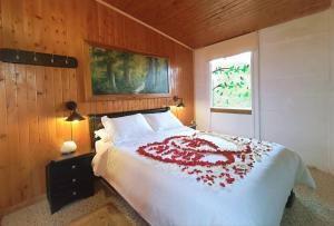 Un dormitorio con una cama grande con una manta roja. en Chalé de montaña con Jacuzzi, en Guarne