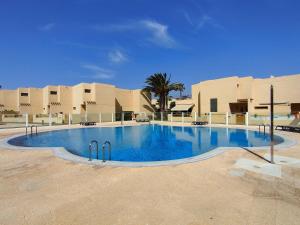 a large swimming pool in front of a building at La Tejita Ocean Villa in Granadilla de Abona