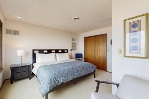 a bedroom with a bed and a table and a chair at 2 Bed 2 Bath Vacation home in Waldport in Waldport