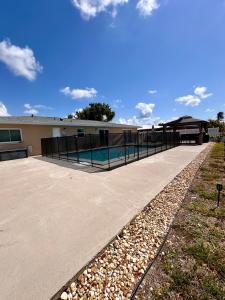 a swimming pool with a fence around a building at Rotonda Pool Oasis Near Beaches - Sleeps 9 in Rotonda West