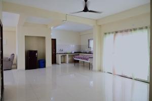 a large living room with a couch and a table at Feel Like Home Rushikonda in Visakhapatnam
