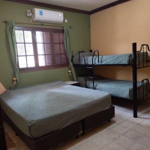 two bunk beds in a room with a window at Hostal Lo de Ramona in Belén