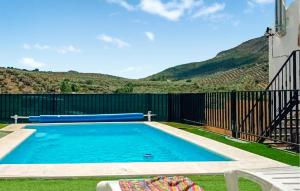 a swimming pool in the yard of a house at Beautiful Home In Priego De Cordoba in Priego de Córdoba