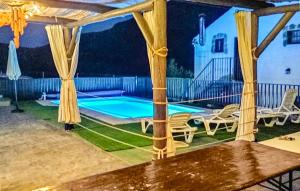 a patio with a swimming pool at night at Beautiful Home In Priego De Cordoba in Priego de Córdoba