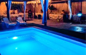 a swimming pool in a room with a table and chairs at Beautiful Home In Priego De Cordoba in Priego de Córdoba +5 photos