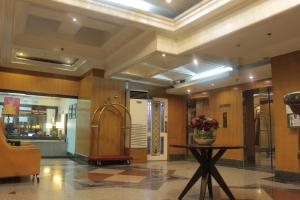 a lobby with a vase of flowers on a table at Prince Plaza II Condotel in Manila +50 photos