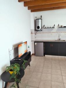 a kitchen with a sink and a counter top at Cómodo Departamento 2 Ambientes in Guaymallen +17 photos