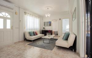 a living room with two chairs and a table at Gorgeous Home In Ciudad Quesada in Ciudad Quesada