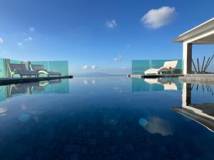 a swimming pool with a view of the water at Villa Best View Samui managed by Villa For You in Koh Samui