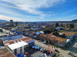an aerial view of a city with buildings and cars at Acogedor departamento en Temuco in Temuco +6 photos