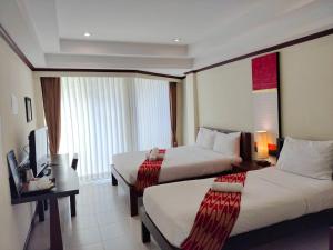 Postel nebo postele na pokoji v ubytování Khon Kaen Orchid Hotel