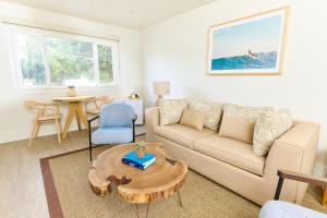 a living room with a couch and a table at Laguna Surf Lodge by SCP Hotels in Laguna Beach