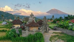 an old building with a mountain in the background at Sama Villa Amed in Amed +17 photos