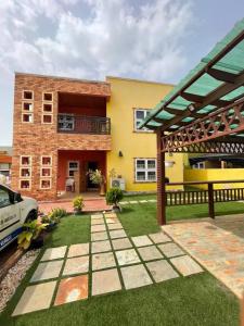 a house with a yard with a patio at Chez nous house in Accra