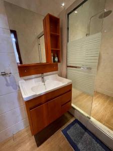 a bathroom with a sink and a shower at Chez nous house in Accra