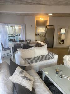 a living room with white couches and a table at BRISA de MAR in Valeria del Mar +30 photos