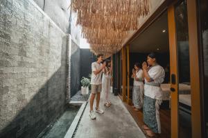 a group of people taking pictures in a hallway at Canggu Cabana Resort By Ini Vie Hospitality in Canggu