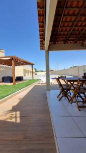 a group of picnic tables on a patio at Dunas residence casa 15- Lençois Maranhense in Santo Amaro