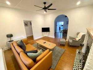 a living room with a couch and a table at No 4 Giles in Kingscote