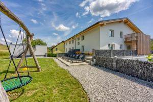 a backyard with a swing and a house at VILA LISJAK - Apartments in Podčetrtek +69 photos