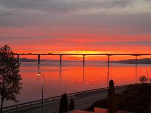 einen Sonnenuntergang über einer Brücke über einen Wasserkörper in der Unterkunft Casa Mundo Bed & Breakfast in Vejle