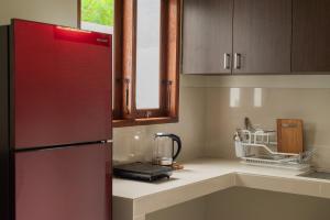 a kitchen with a refrigerator and a counter top at Terrace Mumbul in Nusa Dua