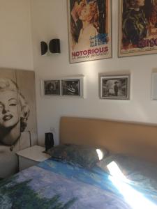 a bedroom with a bed and posters on the wall at Amazing Flat with terrace in Milan