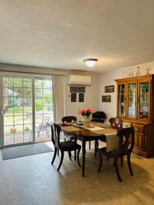 a dining room with a table and chairs and a window at Emerald City 3 Bedroom 1 bath Home in Eugene