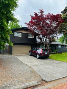 a red car parked in front of a house at Emerald City 3 Bedroom 1 bath Home in Eugene