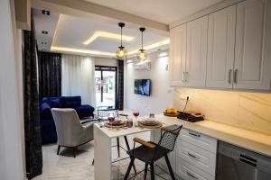 a kitchen and living room with a table and chairs at Gökova Nergis Evleri in Milas +20 photos