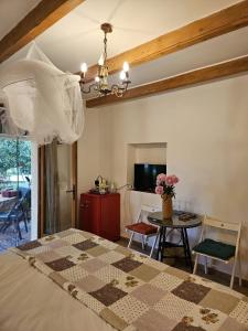 a bedroom with a bed and a table with chairs at La Maison de Blu in Lorgues +30 photos