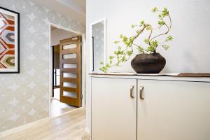 a vase sitting on top of a cabinet in a room at Bijou Suites Pine Brook 405 in Osaka