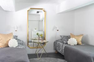 a bedroom with two beds and a mirror at Upea loftsuite, järvinäkymä, wifi, sauna & spa in Tampere +38 photos