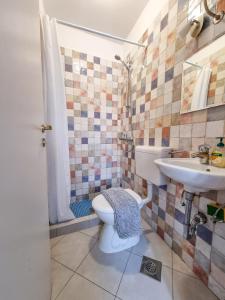a bathroom with a toilet and a sink at De Spot Guest House - Pile Old Town Gate in Dubrovnik