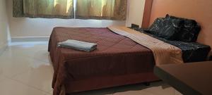 a bedroom with a bed with a brown comforter at 1 Bedroom Furnished Condo Park Lane 812 in Jomtien Beach