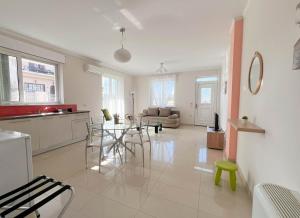 a kitchen and living room with a table and chairs at ARIA Luxury Apartments in Nafplio