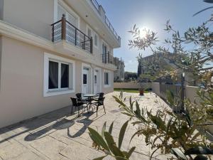 a patio with chairs and a table in front of a building at ARIA Luxury Apartments in Nafplio